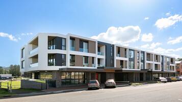 A multi-story hotel with a modern architectural design, featuring large windows and balconies.