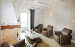 A living room with a fireplace, leather chairs, a coffee table, and a balcony with a view. - Lovely home in St Julien du Gua with WiFi (St Julien du Gua)