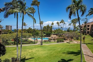 A resort with a swimming pool, palm trees, and a view of the ocean. - Kaanapali Royal | Ocean View 6 BR, Sleeps 19 | Car Incl. w/ 6+ Nights | KRO ML-3797 by KBM (Lahaina)