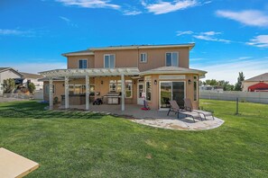 A two-story house with a covered patio, a barbecue grill, and a pool. - Ultimate Group Getaway: 3 min from Lake, vineyards, event centers + Hot Tub (Caldwell)