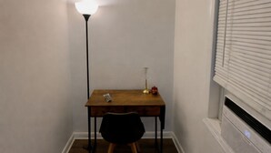 A small room with a desk, chair, lamp, and window with blinds. - Ariia Fort Lauderdale Airport (Fort Lauderdale)