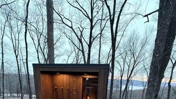 A wooden cabin with a fireplace, a stone pathway leading to it, and a forested backdrop. - Luxury Mirror Cabin with Lake View - Nature (Mountainburg)