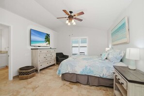 A bedroom with a bed, a ceiling fan, a TV, a dresser, a chair, and a window with blinds. - Family Beach Retreat | Heated Pool | Sleeps 8 | Near Beach (Bonita Springs)