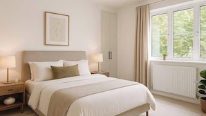 A bedroom with a bed, bedside tables, a window with curtains, a radiator, and a wall-mounted light fixture. - Cozy Urban Retreat in Wolverhampton (Wolverhampton)