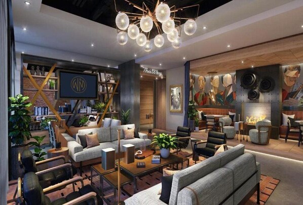 A modern interior with a sofa, chairs, a coffee table, and a fireplace. - Hotel West & Main Conshohocken Philadelphia, Tapestry by Hilton (Conshohocken)