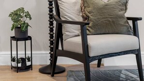 A modern room with a floor lamp, a chair, a small table with plants, and a patterned rug. - The Luxury Secret Garden Retreat 3 bed 2 Bath (London)