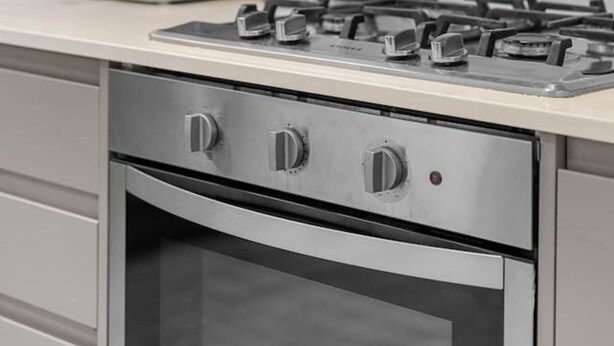 A kitchen with a gas stove, a coffee machine, and a toaster. - The Luxury Secret Garden Retreat 3 bed 2 Bath (London)
