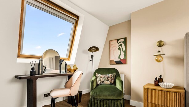 A room with a desk, chair, green armchair, lamp, and artwork. - The Luxury Chic Duplex Apartment 2 Bed 2 Bath (London)