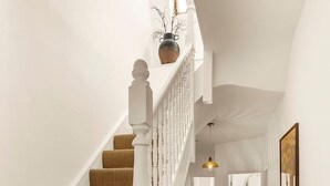 A staircase with a white railing, a brown carpeted floor, and a pendant light. - The Luxury Chic Duplex Apartment 2 Bed 2 Bath (London)