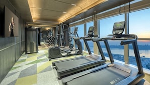 A gym with treadmills, elliptical machines, and weight equipment. - Ascott Hankou Riverside Wuhan (Wuhan)