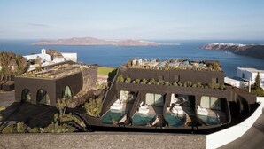 A modern hotel with a rooftop pool, offering views of the sea and distant islands. - One of One - Adults Only (Santorini)