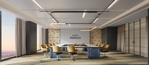 Una sala conferenze moderna in hotel con un lungo tavolo, sedie e vista sulla città.