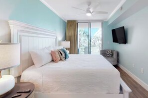 A hotel room with a bed, a TV, a chair, and a window with a view. - Beachfront • Lazy River • Sleeps 8 • C305 (Fort Walton Beach)