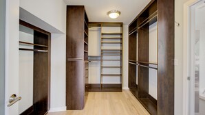 A walk-in closet with multiple shelves and drawers, wooden doors, and a light fixture on the ceiling. - Hollywood Hills - Universal Studios- 4Bedroom- Sunset Views!!! (Los Angeles)