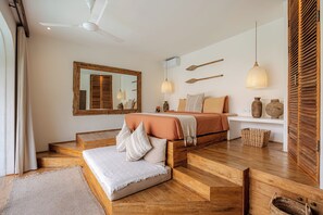A bedroom with a bed, a mirror, a ceiling fan, and wooden flooring. - Luxury 3BR Mediterranean Villa w/ Bfast & Butler (Badung)