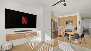 A modern kitchen with a built-in microwave, a stainless steel refrigerator, and wooden cabinets. - Cozy Midtown Retreat 2BR/2BA PRIVATE GARAGE (Sacramento)