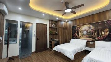 A bedroom with two beds, a ceiling fan, recessed lighting, a shower, and a mural on the wall.