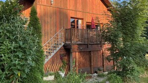 Un edificio in legno con un balcone, una scala e un'uscita.
