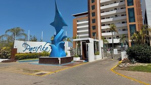 A hotel entrance with a large blue sculpture, a sign with the hotel's name, and a multi-story building in the background. - Near the beach, with a terrace and beautiful views (Mazatlán)