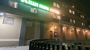 A hotel named 'Kiwi Inn' with a signboard, multiple windows, and a gated entrance. - Kiwi Inn Hotel Palda (Indore)