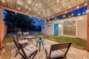 An outdoor patio area with seating and string lights. - Your Houston home base near the Medical Center, NRG, Downtown, and top attractions. (Houston)