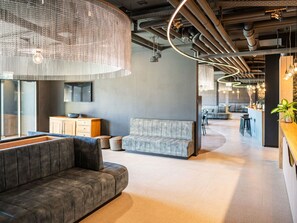 A modern office space with a sofa, a dining area, and a kitchen. - Lovely apartment for 6 people with WIFI, TV, terrace and pets allowed (Les Collons)