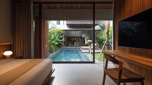 A modern hotel room with a large window, a wooden ceiling, a pool, and a TV. - Savara Villas Canggu (Canggu)