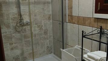 A bathroom with a shower, toilet, and sink.