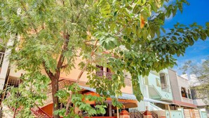 A residential building with a two-story structure, a gated entrance, and a staircase leading to the entrance. - Hotel O Buckingham Canal Vijayawada (Vijayawada)