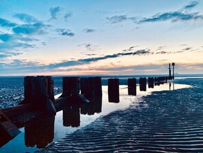 A pier extending into calm water with a sunset in the background. - 5 Spacious 2-Bed Flat Sleeps 4 Secure Parking WiFi (Cleethorpes)