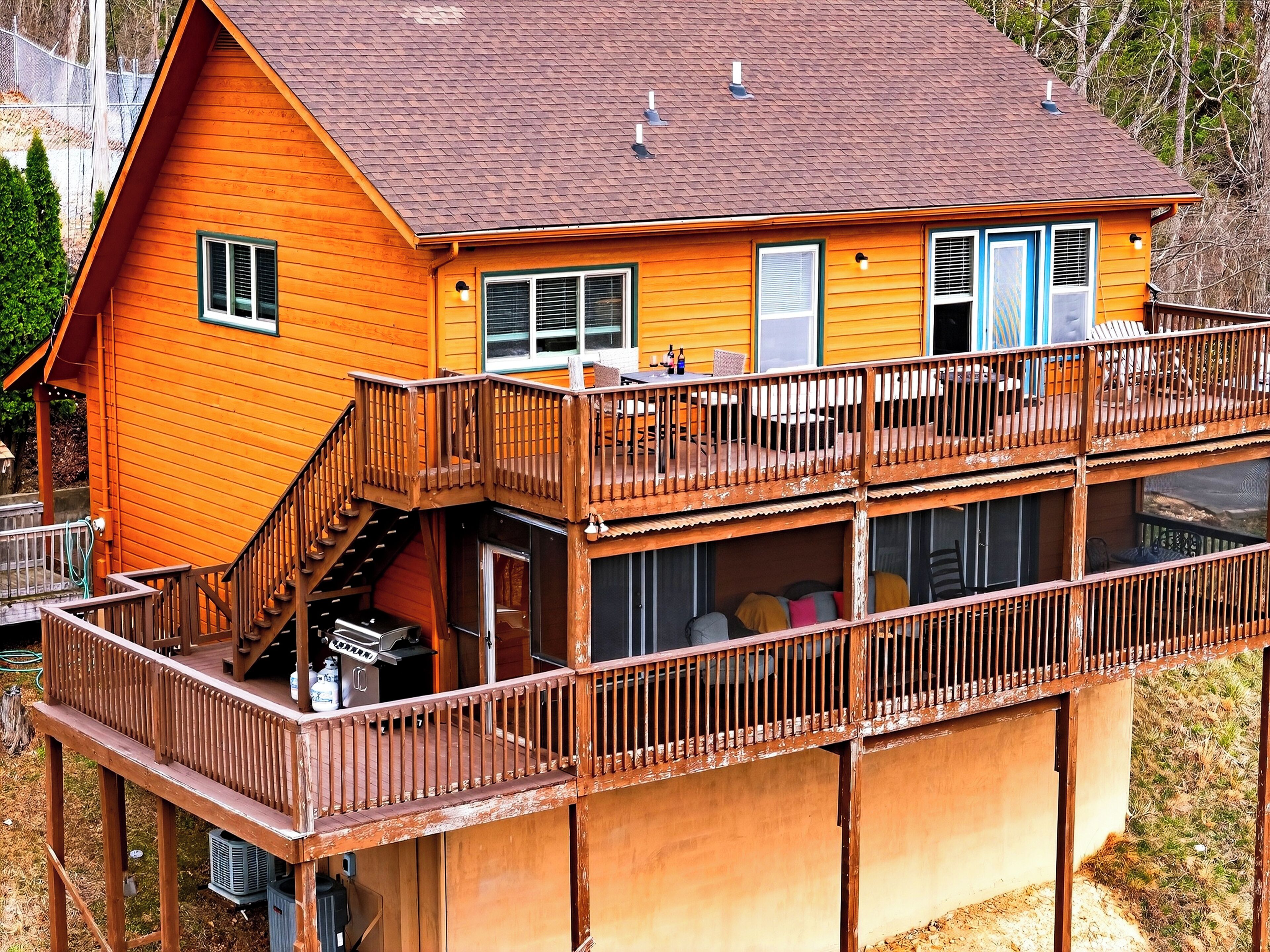 A two-story wooden house with a balcony, a staircase, and a garage.