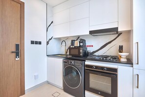 Fridge, microwave, oven, stovetop - Modern Chic Studio Featuring Skyline Views (Dubai)
