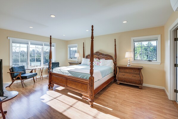 A spacious bedroom with a four-poster bed, a wooden dresser, a nightstand, a chair, and a television. - Sweetmoss Is Lovely! 3 Mi to Acadia Nat'l Park (Mount Desert)