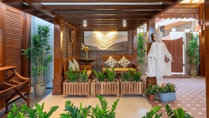 A traditional Japanese-style interior with wooden sliding doors, a tatami mat seating area, and a large statue. - Sstella Empire Beach Resort, a member of Radisson Individuals (Calangute)