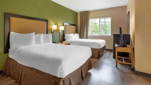A hotel room with two beds, a TV, and a window with curtains. - Studio6 Fishkill 2 Full Beds, Mobil Tub, Nsmk Kitchen (Fishkill)