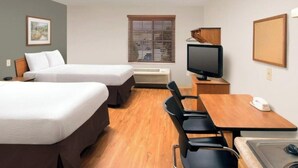 A hotel room with two beds, a desk with a computer, a chair, a small table, a TV, and a window with blinds. - 2 Full Beds | Non-Smoking, Kitchen (Cincinnati OH)