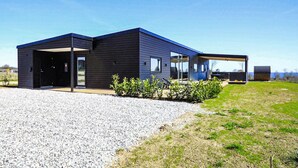 A modern two-story building with a covered outdoor area and a gravel driveway. - Pet friendly home in Børkop with sauna (Børkop)