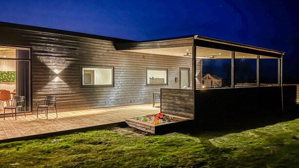 A modern house with a wooden exterior, large windows, and a deck. - Pet friendly home in Børkop with sauna (Børkop)