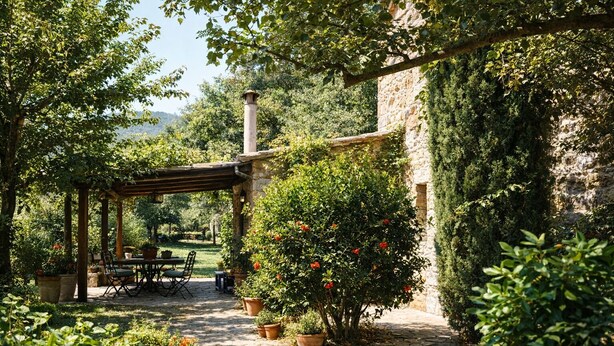 A stone pathway leading to a wooden pergola with a table and chairs, surrounded by potted plants and a stone wall. - I escape to Umbria, Torreluca (todi)