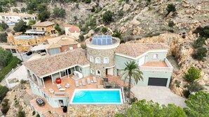Eine Villa mit Swimmingpool, mehreren Zimmern und einem Steinturm.