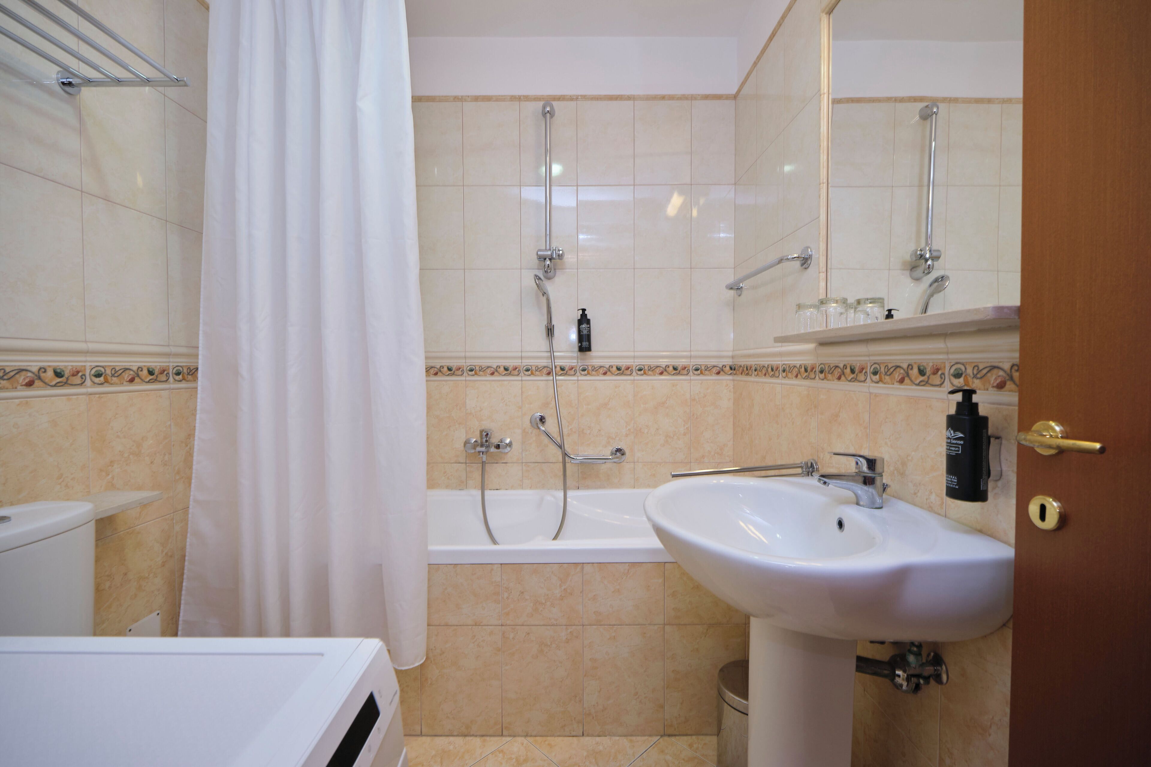 A bathroom with a bathtub, a sink, and a shower.