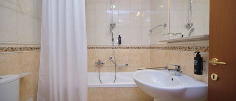 A bathroom with a bathtub, a sink, and a shower.