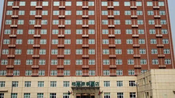 Un edificio de hotel de varios pisos con fachada de ladrillo rojo y numerosas ventanas.