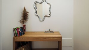 A wooden table with a mirror, books, and a decorative item on it. - Etherio Naxos Anemos Tranquil 2-bedroom apartment with AC in beautiful Naxos (Naxos)