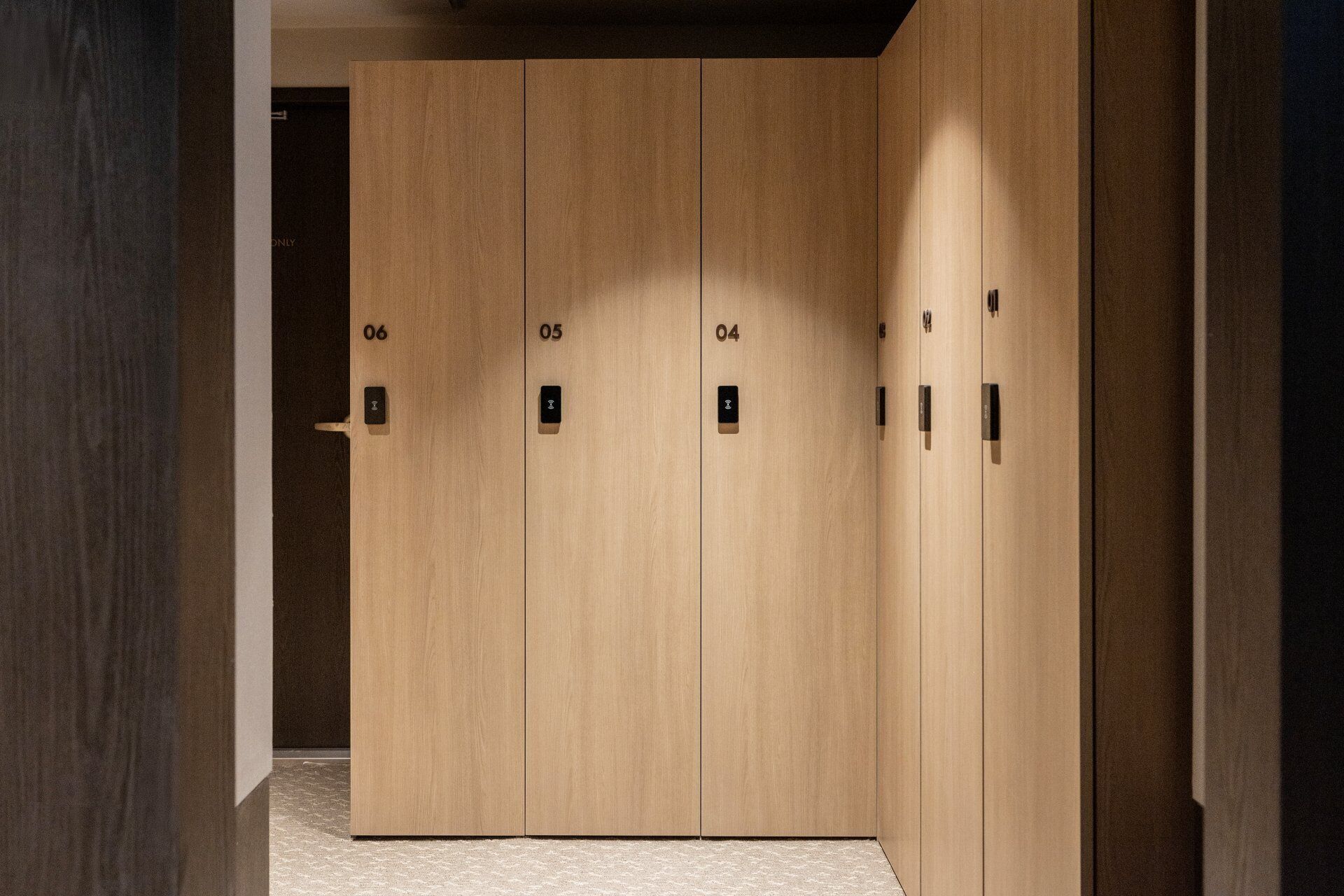 A set of wooden double doors with numbered locks, indicating a private room or suite.