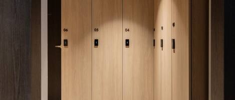 A set of wooden double doors with numbered locks, indicating a private room or suite.