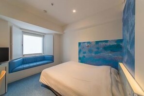 A bedroom with a bed, a window seat, a painting, and a television. - Hotel ART Stay Naha Kokusai Street (Naha)