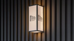 A modern wall-mounted light fixture with a minimalist design and the text 'ANOOK RYOKA' on it. - Anook Ryokan Hotel Daejeon Yongjeon (Daejeon)