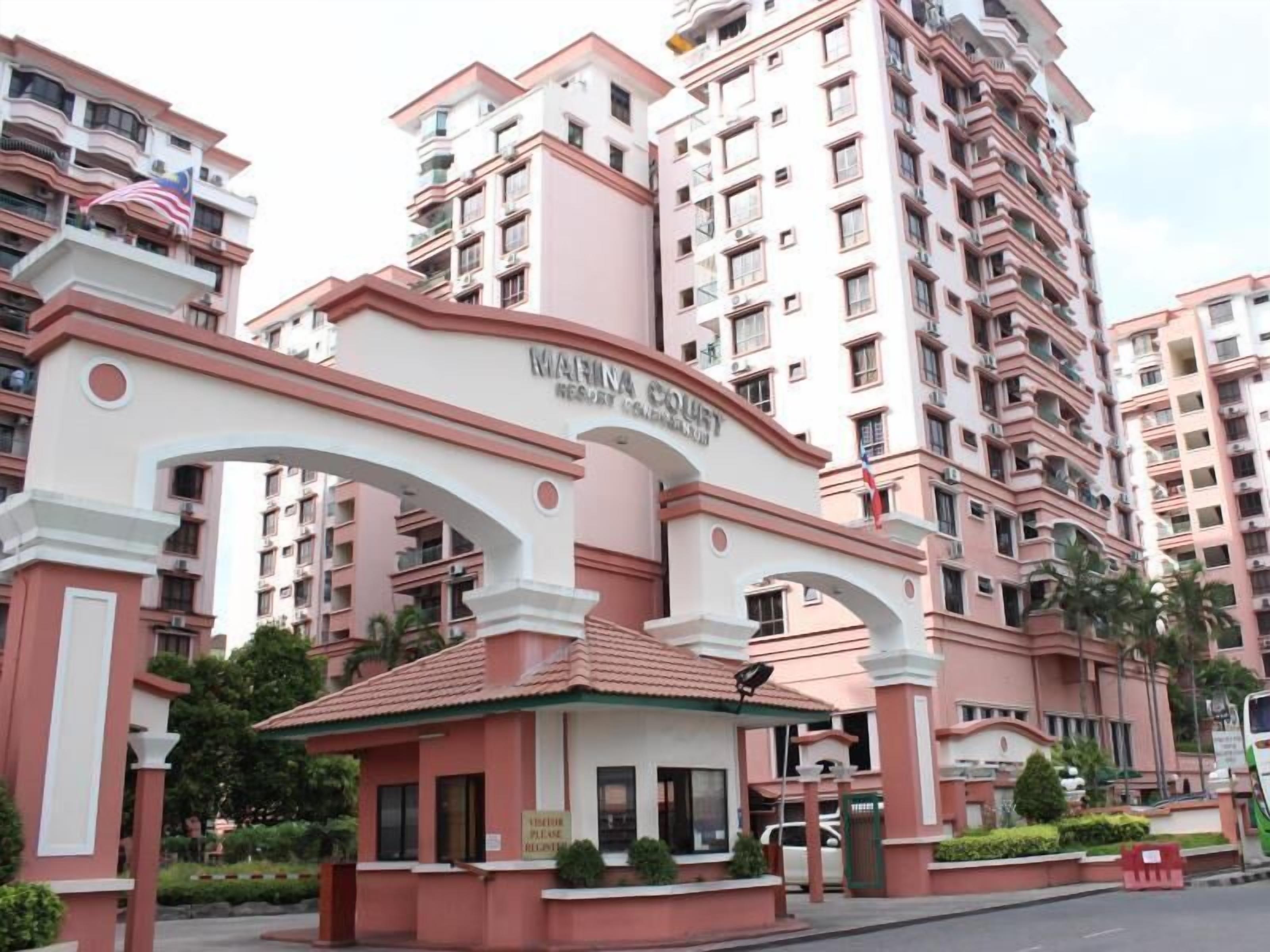 A multi-story building with a prominent archway labeled 'MARINA COURT RESORT.'