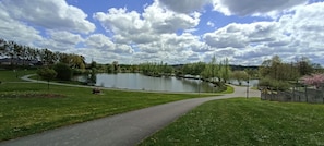 A park with a lake, pathways, and trees.